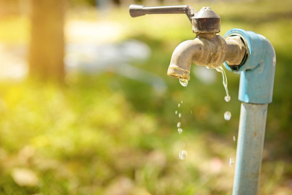 A Close up Of a Faucet with Water Dripping out Of It — Top To Bottom Plumbing in Garbutt, QLD