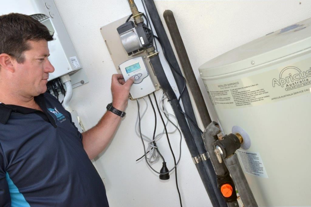 Two Men Are Working on A Metal Object with Wrenches — Top To Bottom Plumbing in Garbutt, QLD