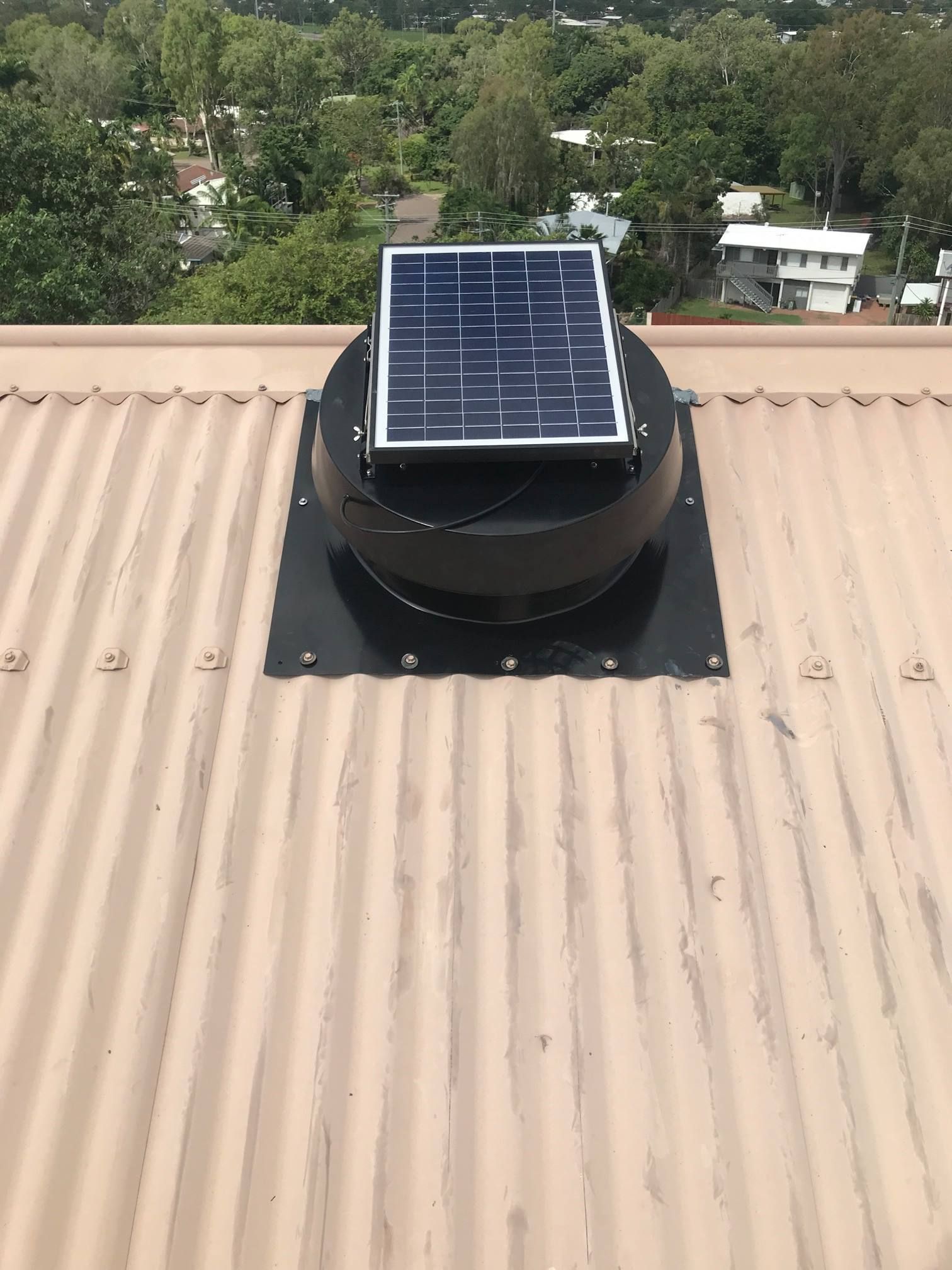 Solar-powered Roof Vent on a Corrugated Metal Roof — Top To Bottom Plumbing in Garbutt, QLD