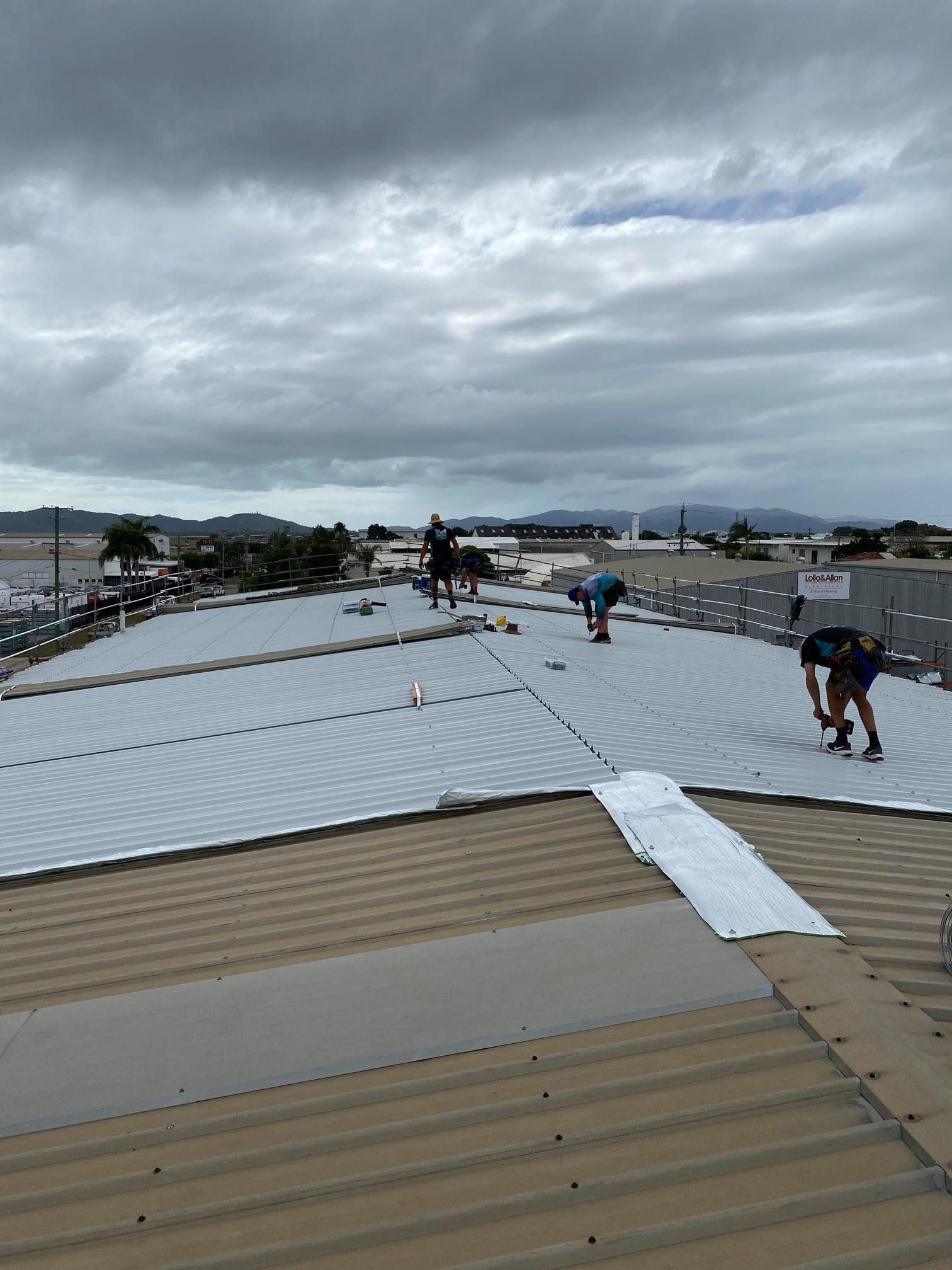 Roofers Fixing Metal Roof After Storm