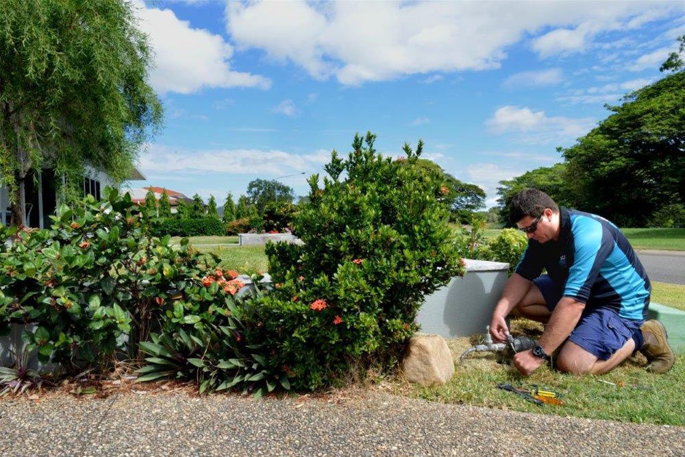 Man Doing Plumbing Maintenance on Water Pipe