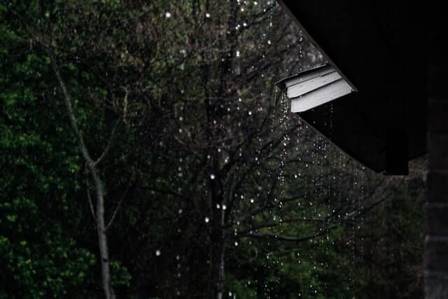 Rain Is Falling from The Roof of A House at Night — Top To Bottom Plumbing in Garbutt, QLD