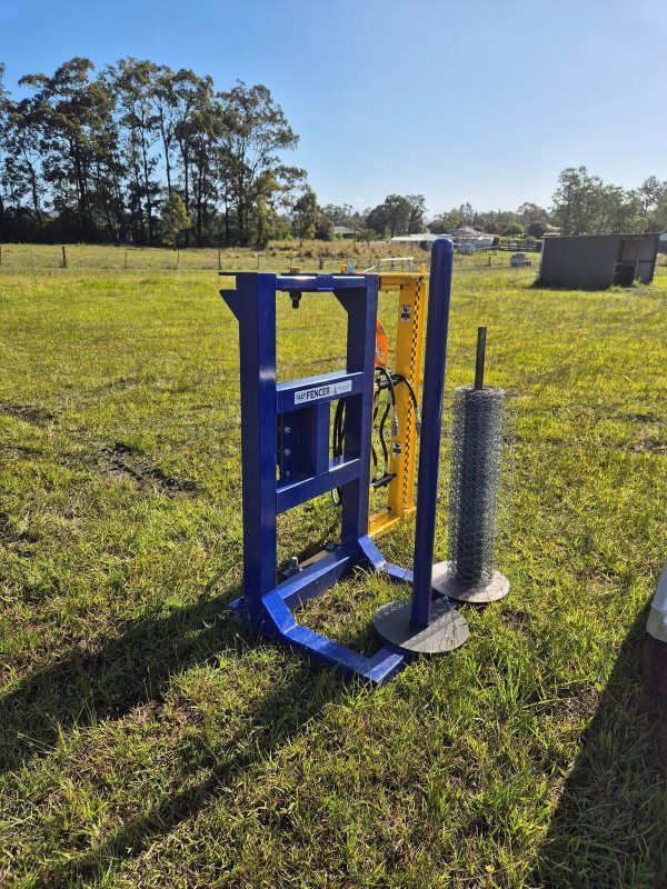 A Hay Bale Wrapper Machine in A Grassy Field — Barry Brown Rural Contracting Service in Tinonee, NSW 