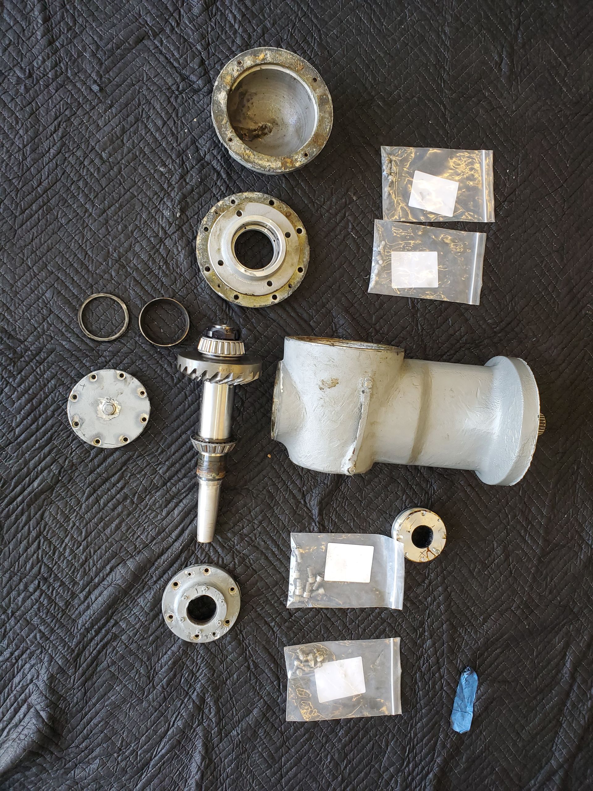 A bunch of metal parts on a black cloth