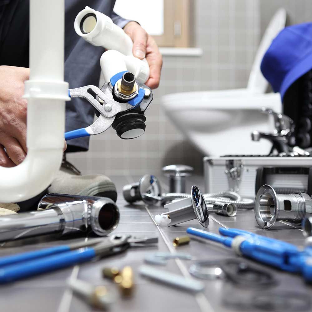plumber at work in a bathroom