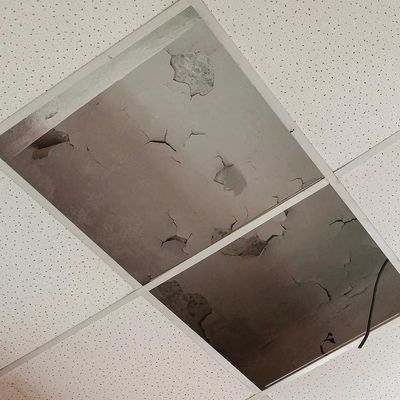 Suspended ceiling with water leaks on floor slabs