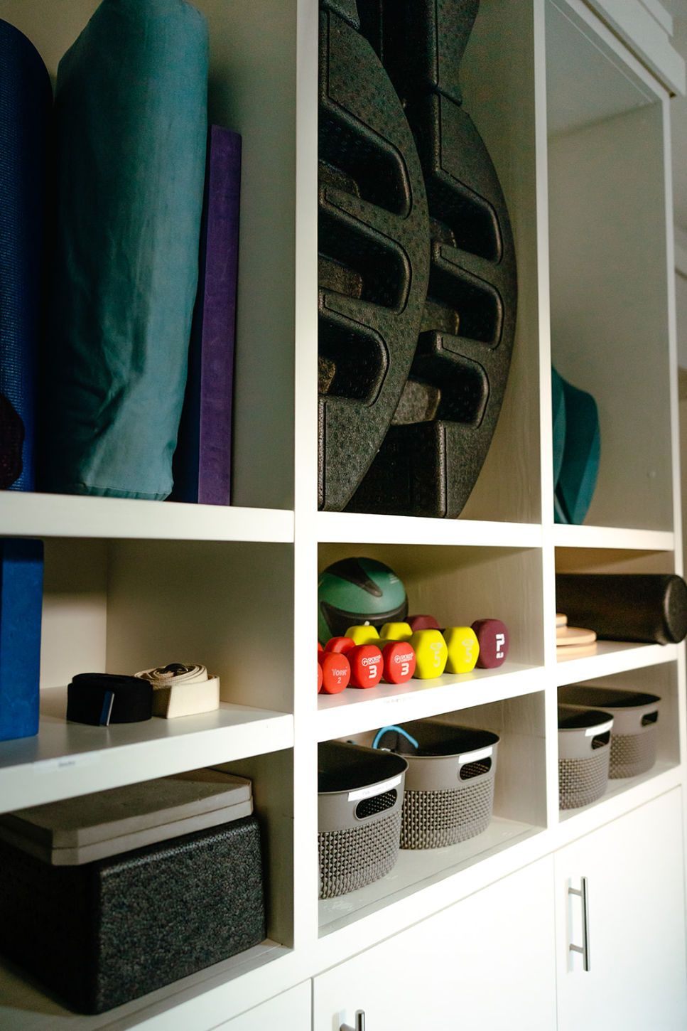 A shelf filled with a variety of sports equipment
