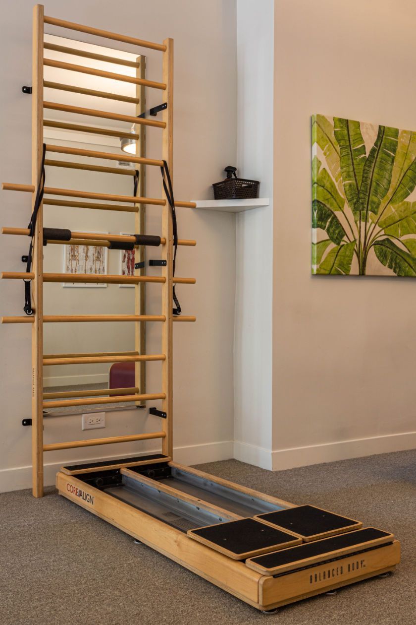 A CoreAlign exercise machine is sitting in a room next to a mirror.