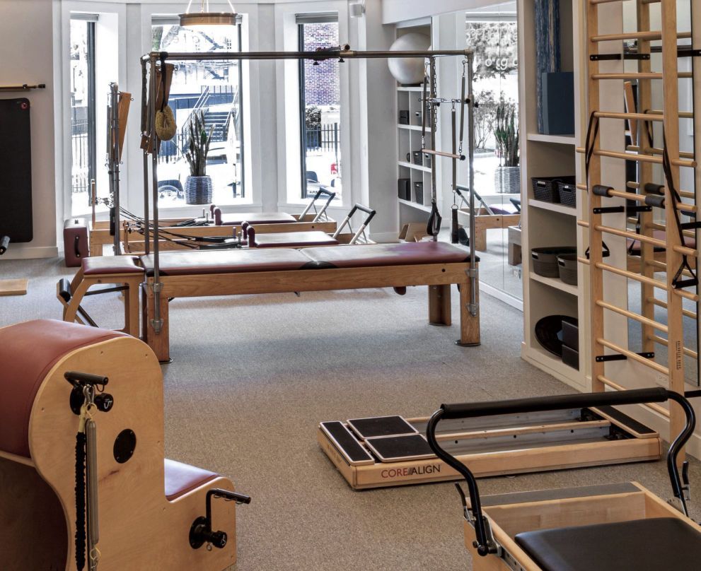 A pilates studio with Pilates cadillac and pilates equipment,