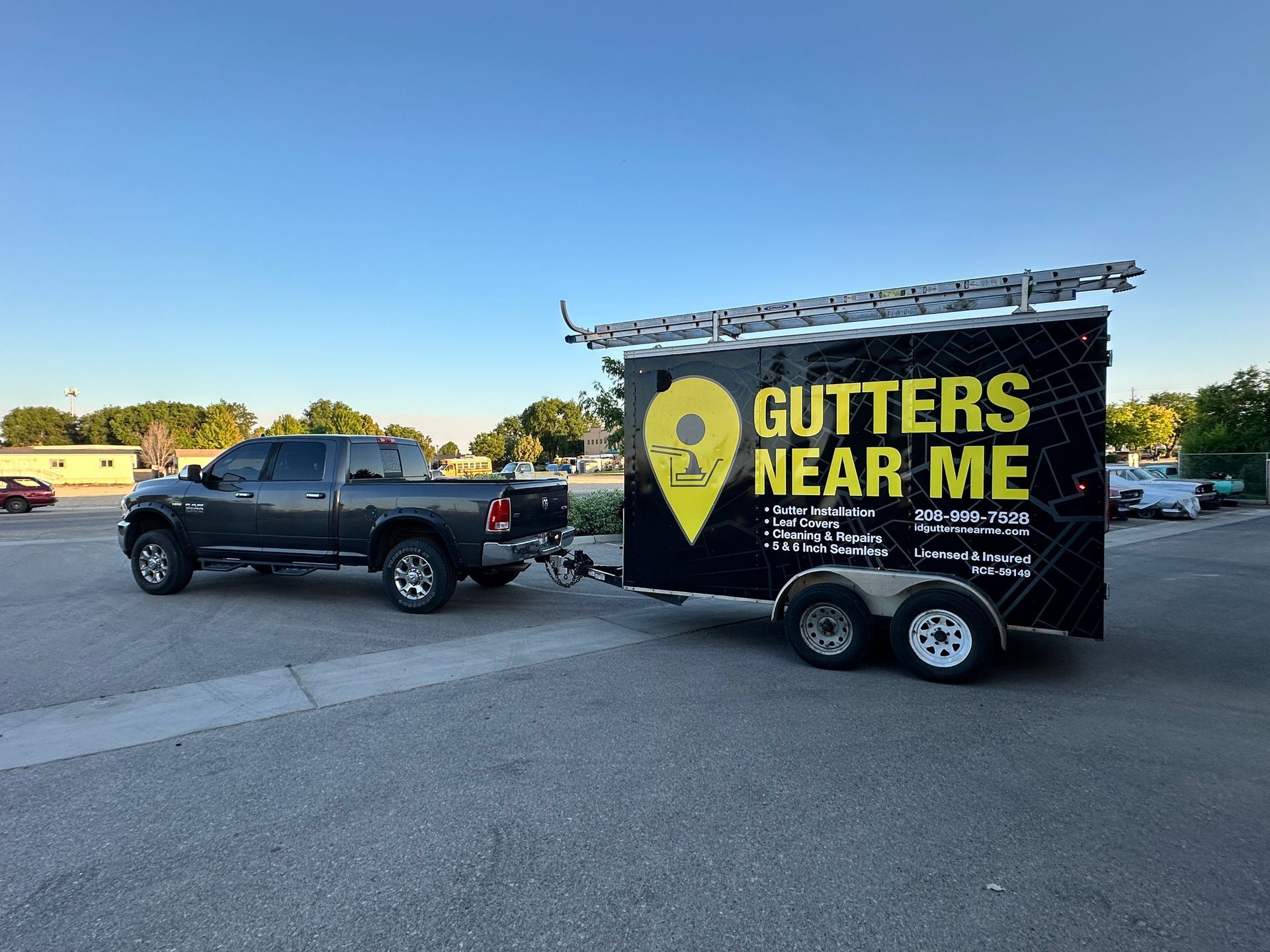 Gray truck towing a black trailer with
