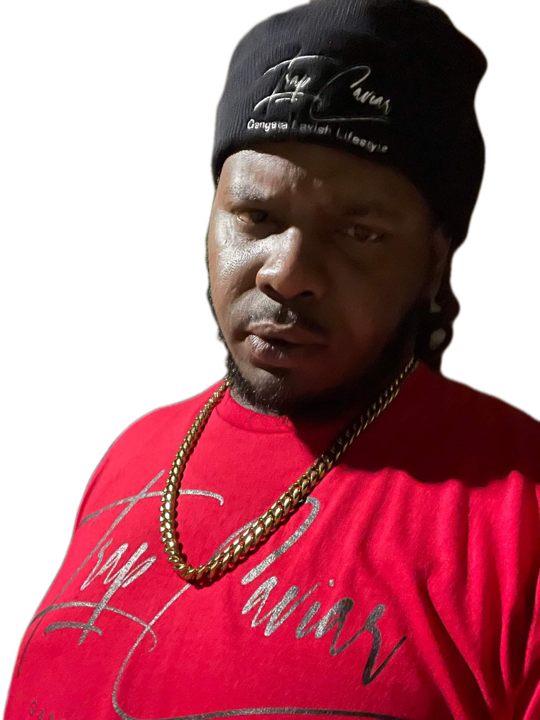 A man wearing a red shirt and a black beanie is looking at the camera.