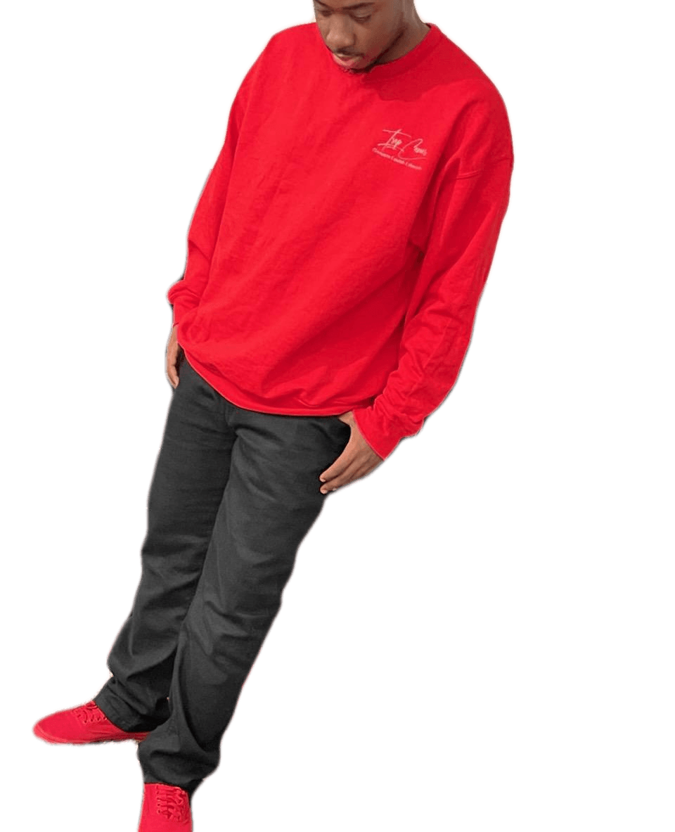 A man wearing a red sweatshirt and black pants