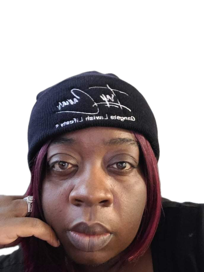 A woman with red hair is wearing a black beanie
