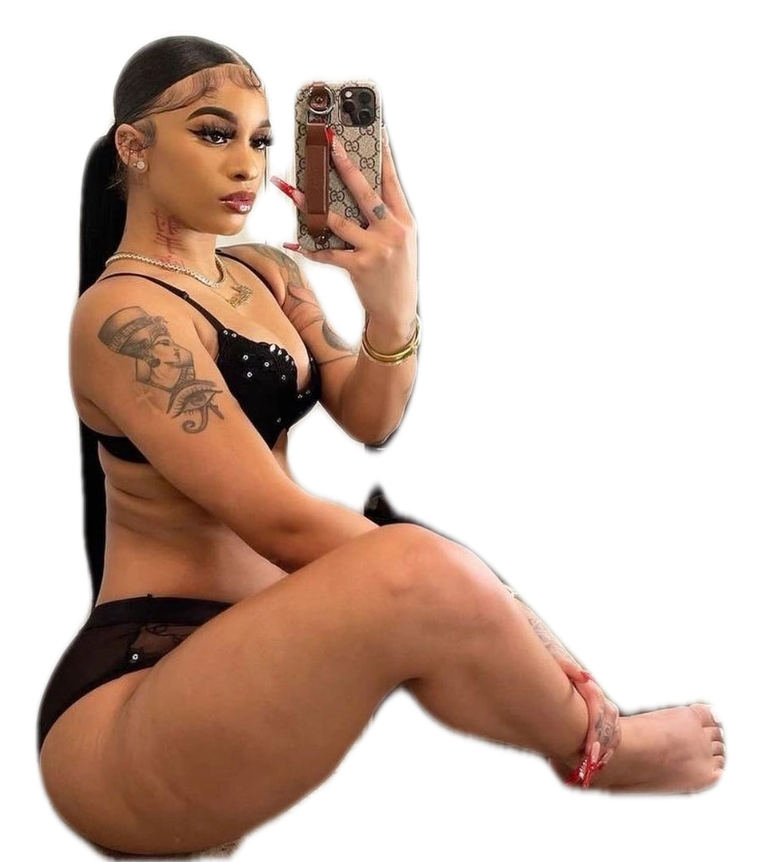 A woman is sitting on the floor taking a selfie with her phone.