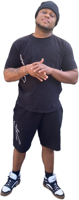 A man in a black shirt and shorts is standing with his hands folded.