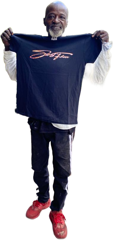 A man is holding a blue t-shirt in his hands.