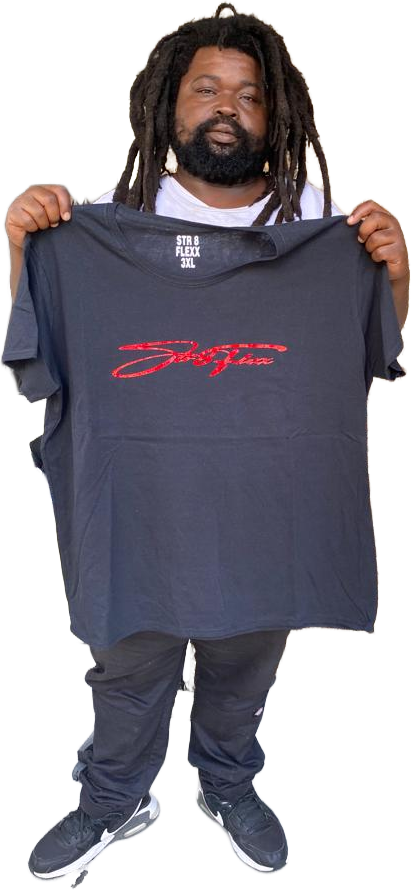 A man with dreadlocks is holding a t-shirt in his hands.