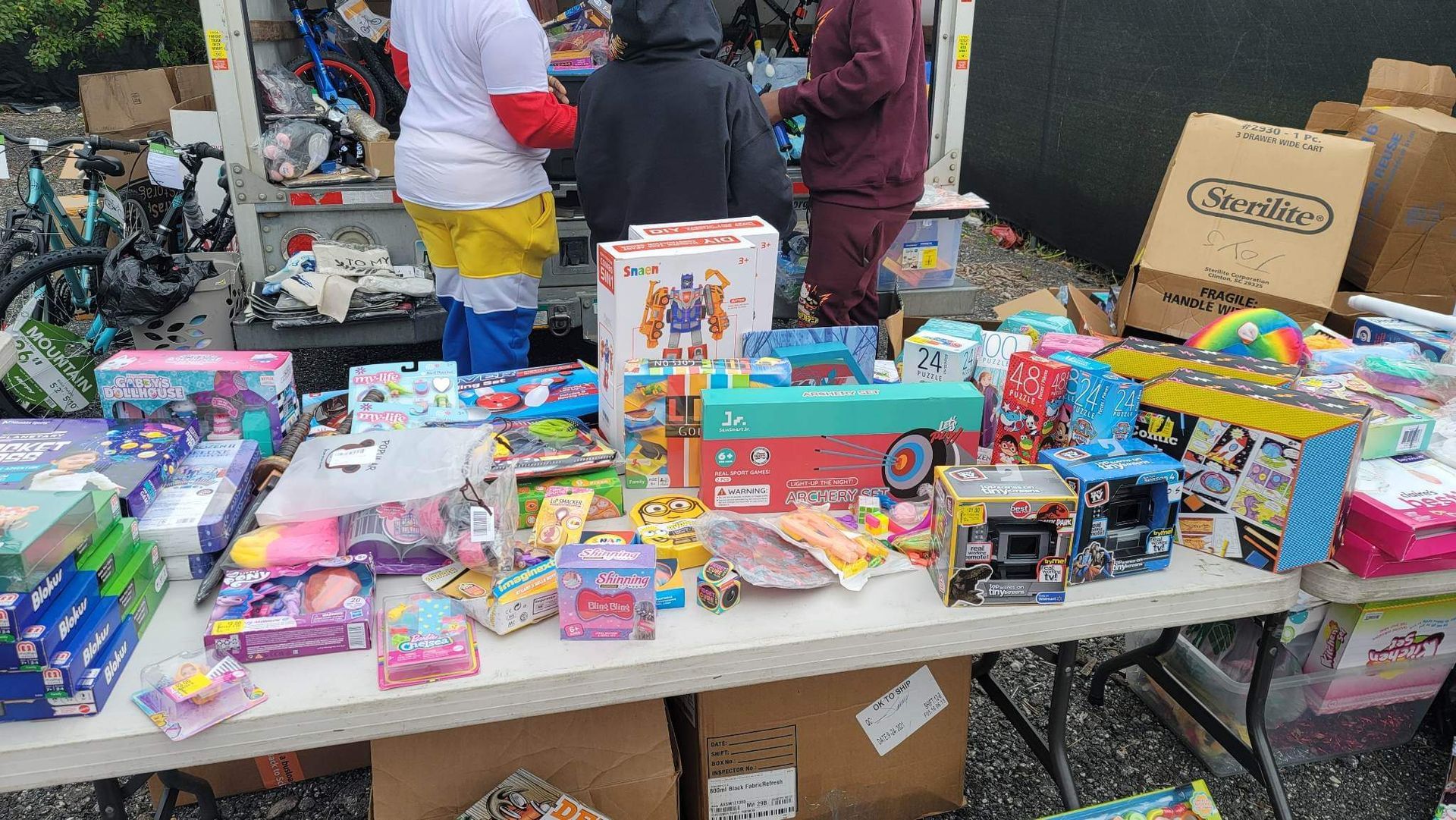 A table filled with lots of toys and boxes.