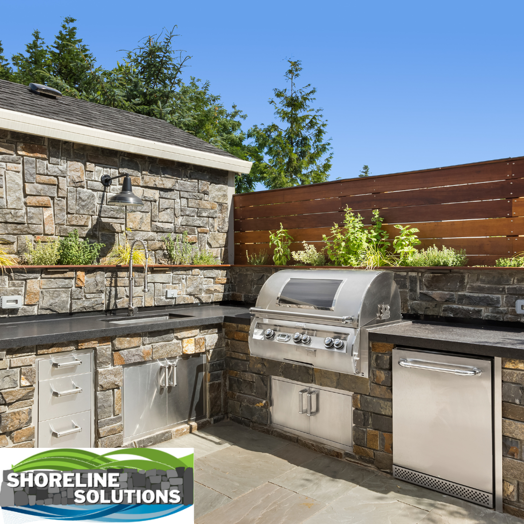 An outdoor kitchen with a grill , sink , and dishwasher.