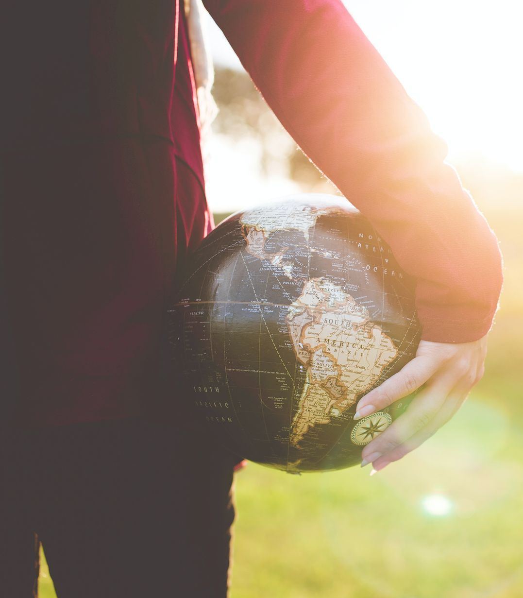 personal holding a globe