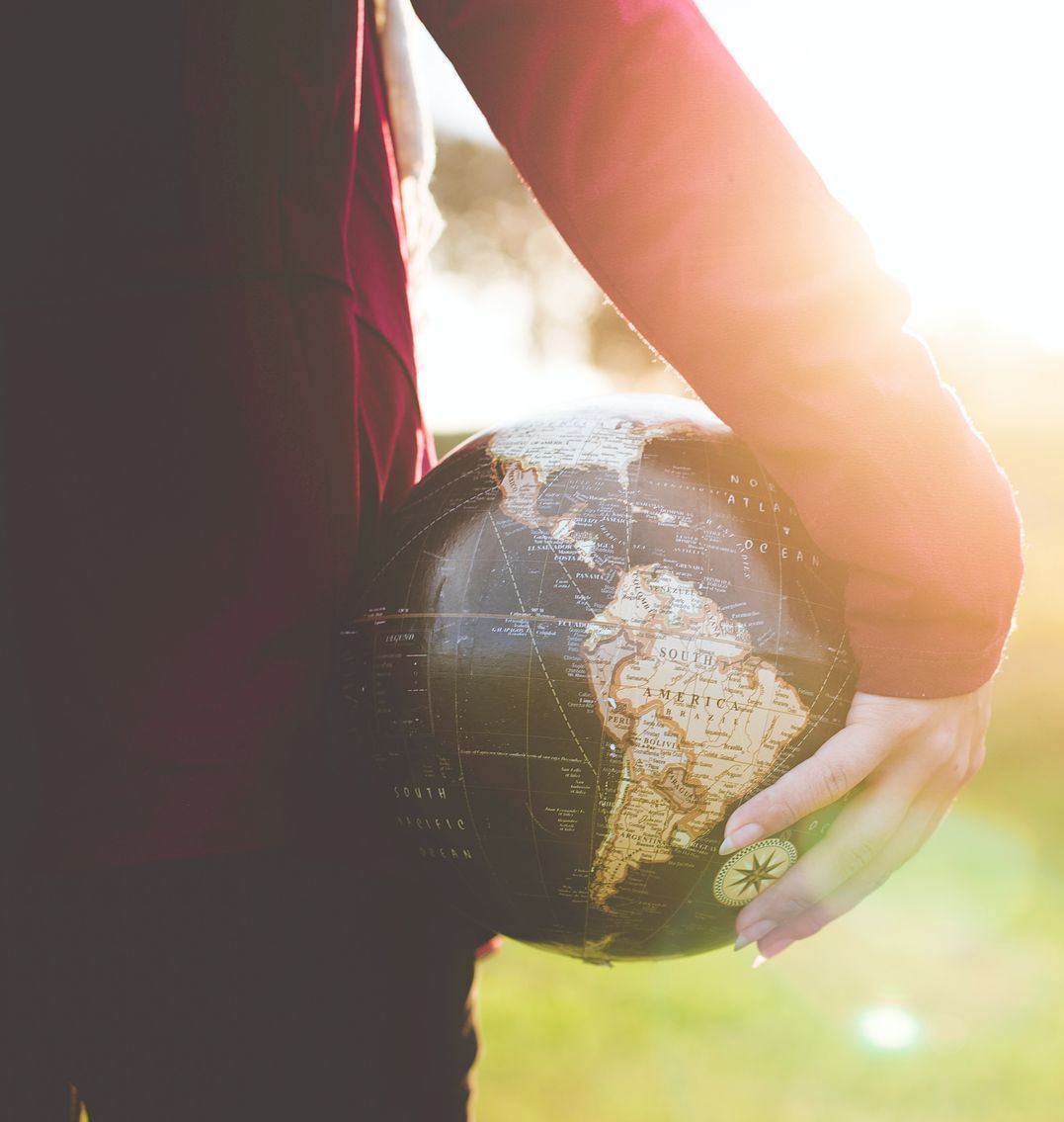 personal holding a globe