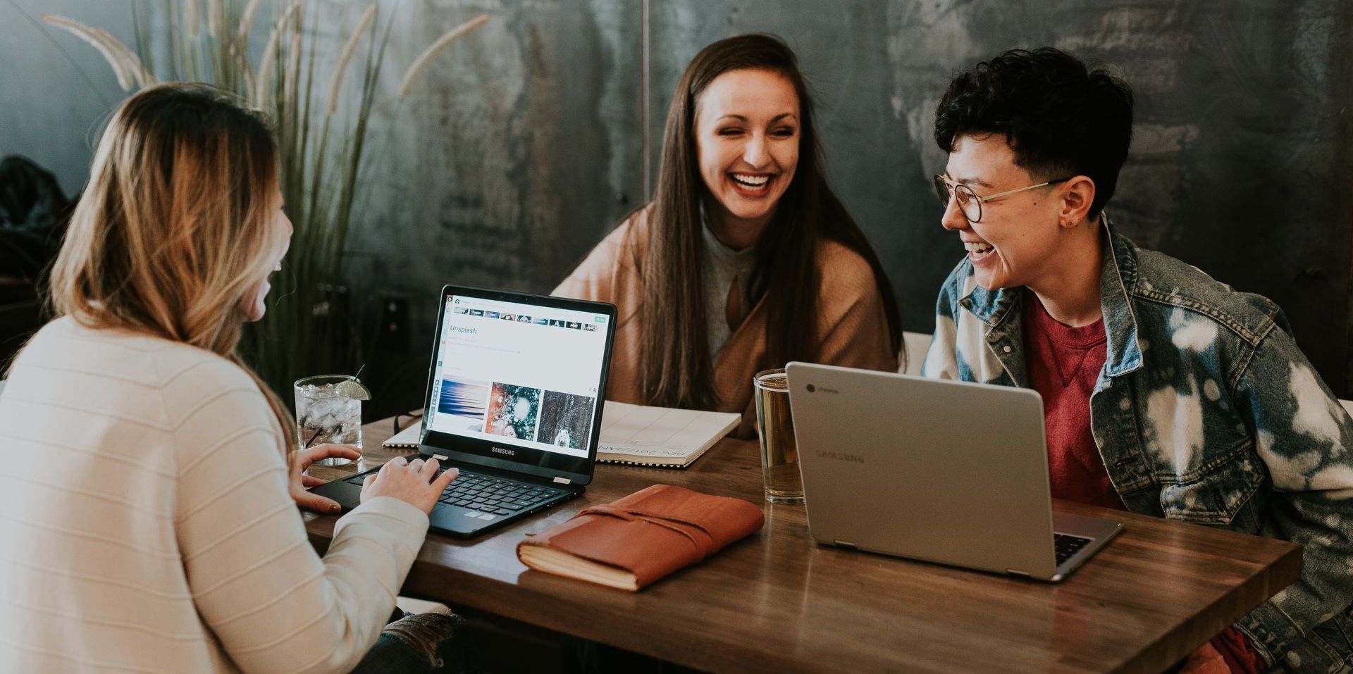 three people on laptops