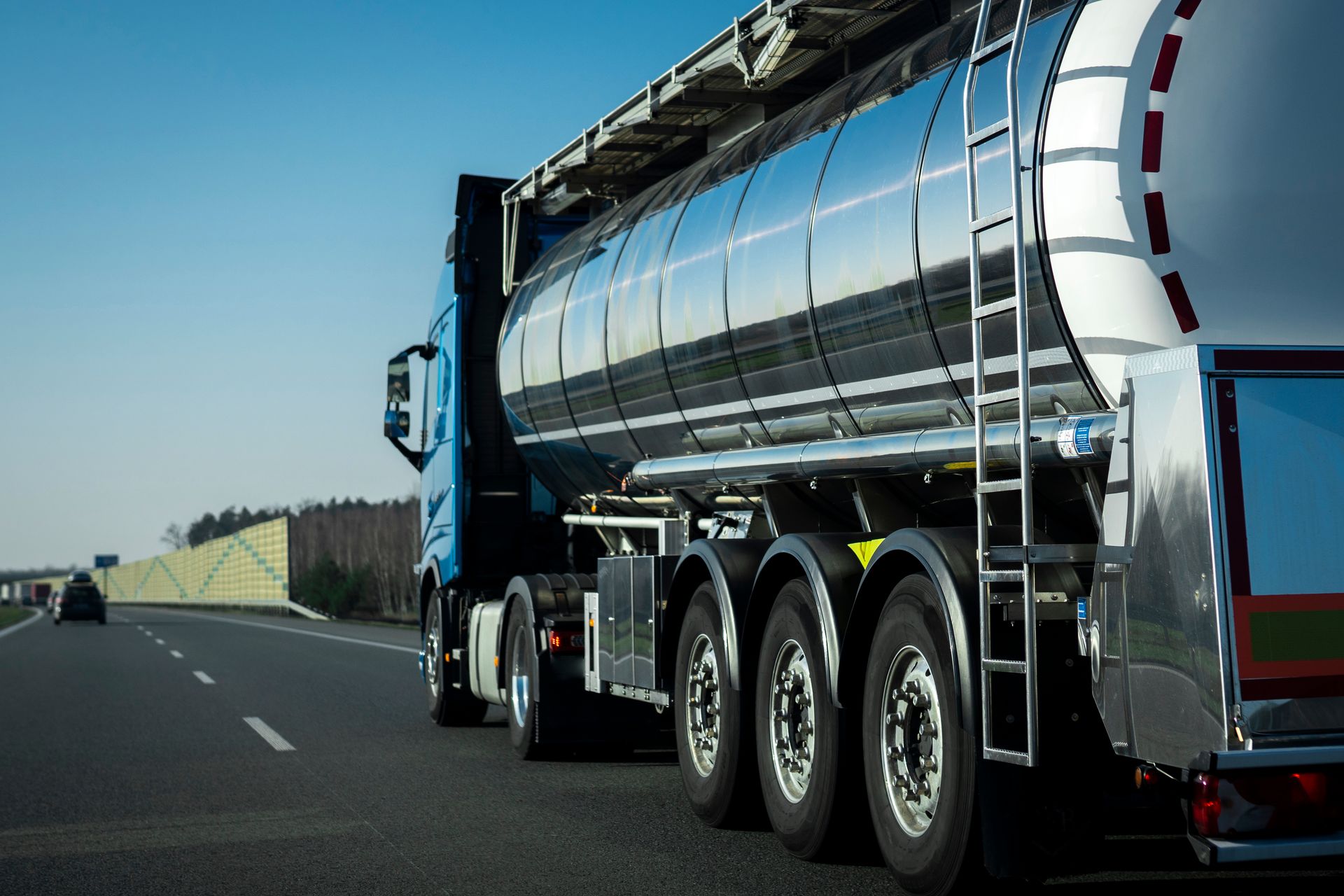 A tanker truck is driving down a highway.
