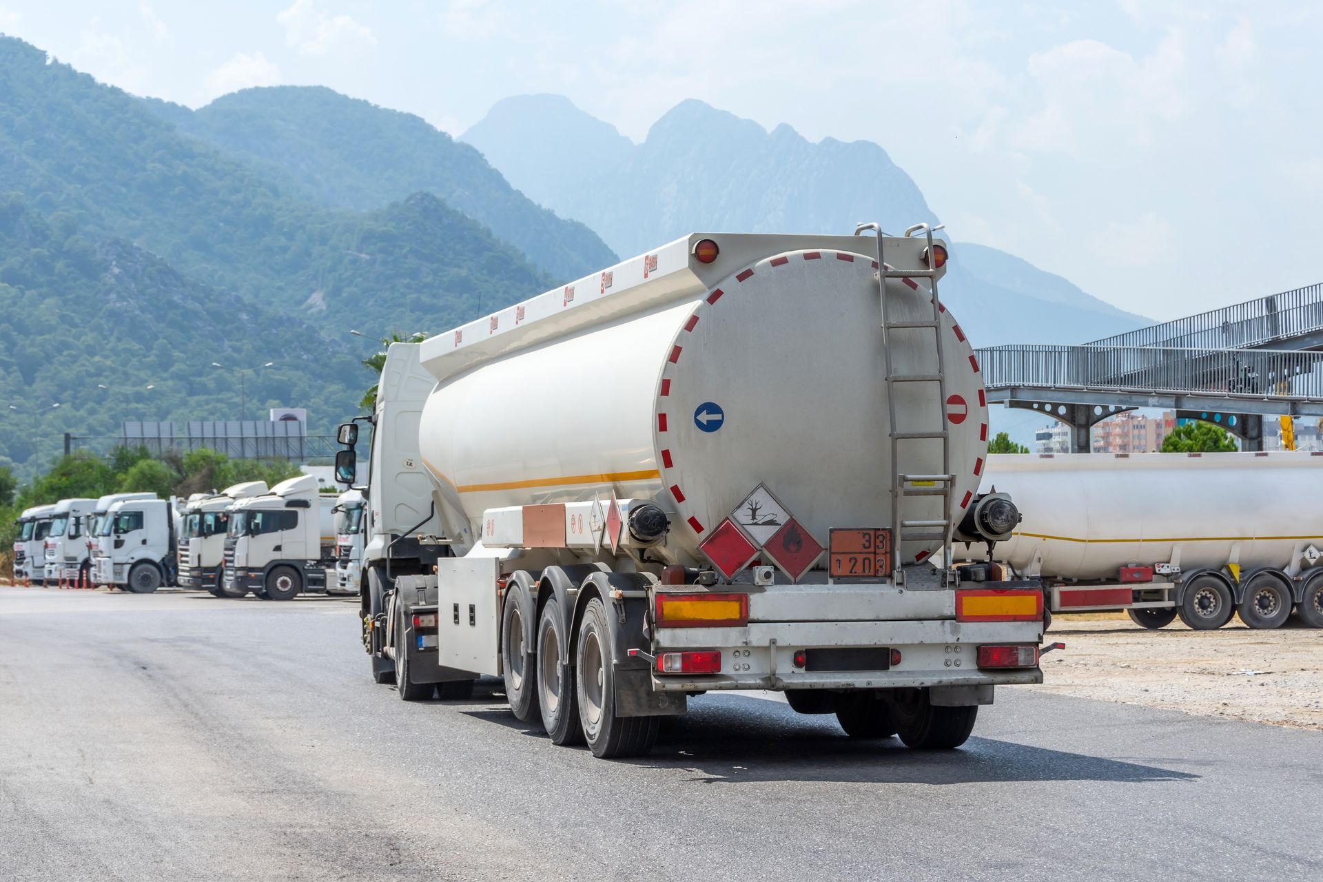 A tanker truck is driving down a road