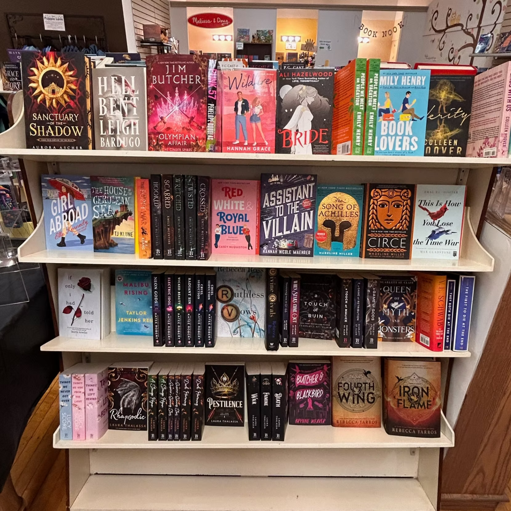 Bookshelf display of colorful horror and thriller novels in a bookstore, with stacked and faced-out covers.