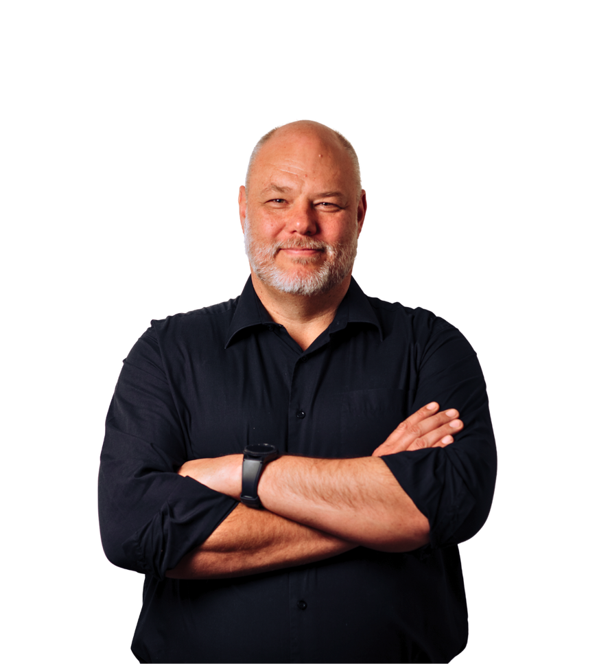 Man in a black shirt standing with arms crossed against a white background