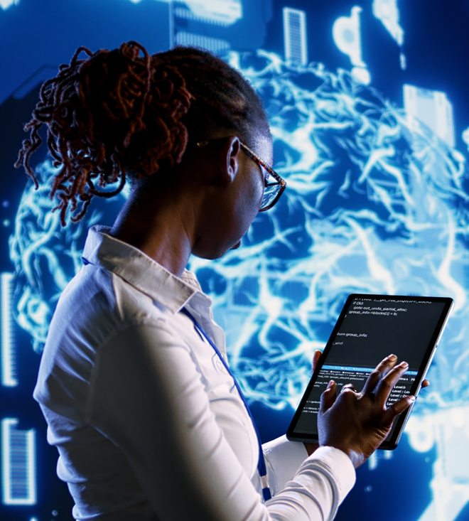 Person using a tablet in front of a glowing blue digital screen