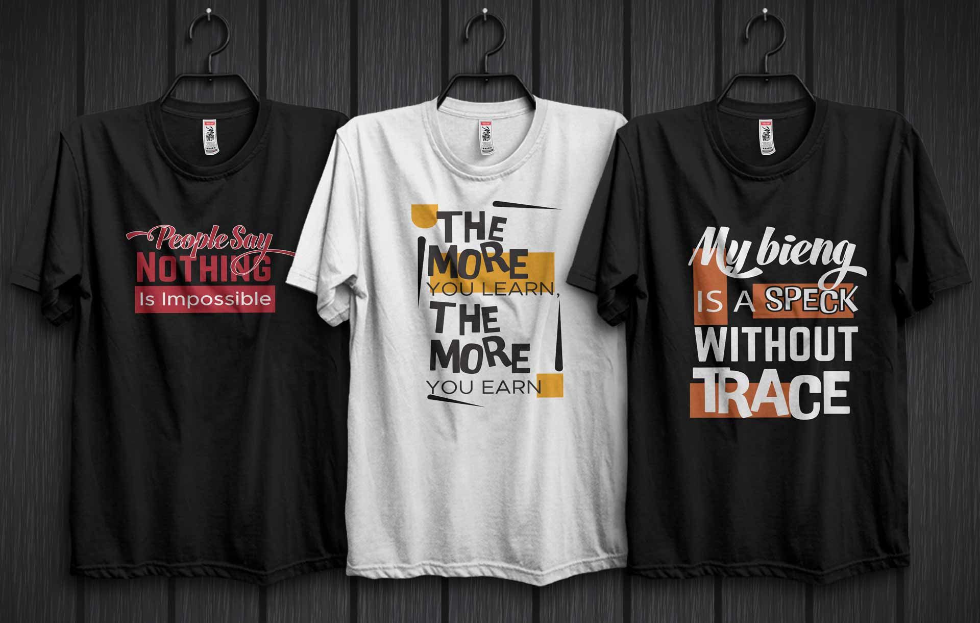 Three graphic T-shirts on hangers, black and white, with bold text designs on a dark wall