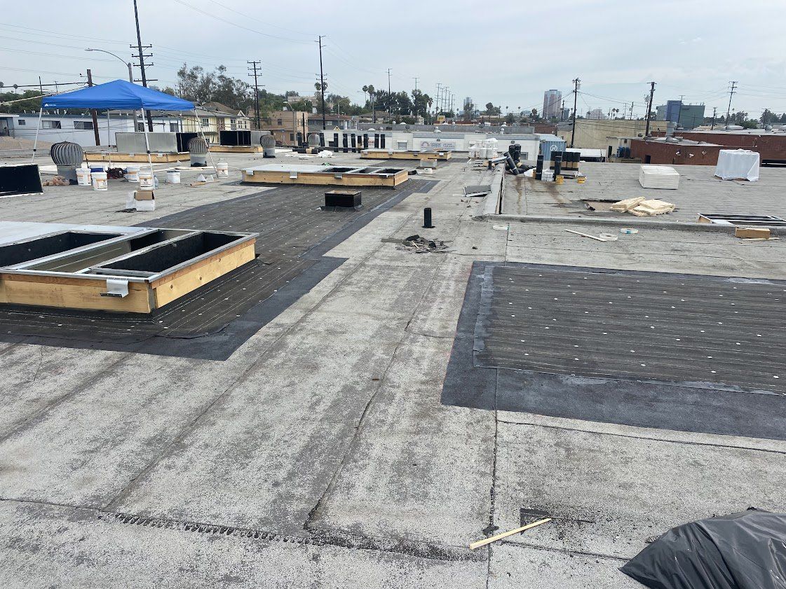 A roof with a lot of holes in it and a blue umbrella in the background.