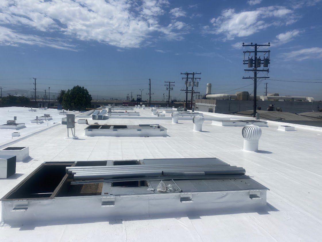 A white roof with a lot of vents on it