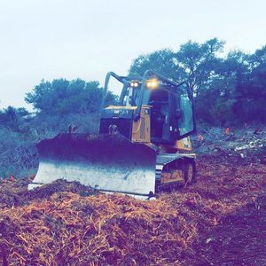 A bulldozer pushing debris on a construction site.
