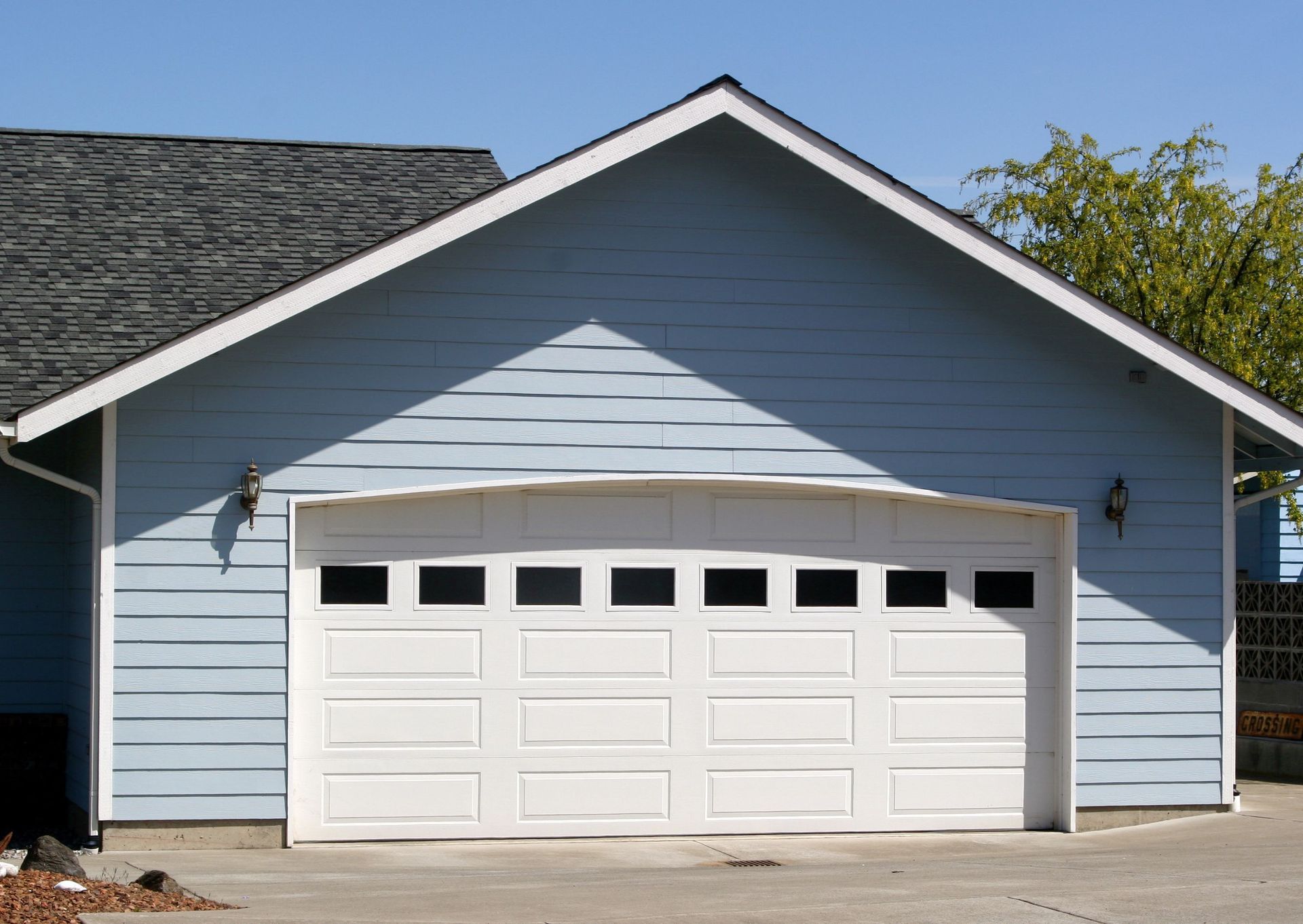 Blue garage with a white garage door.