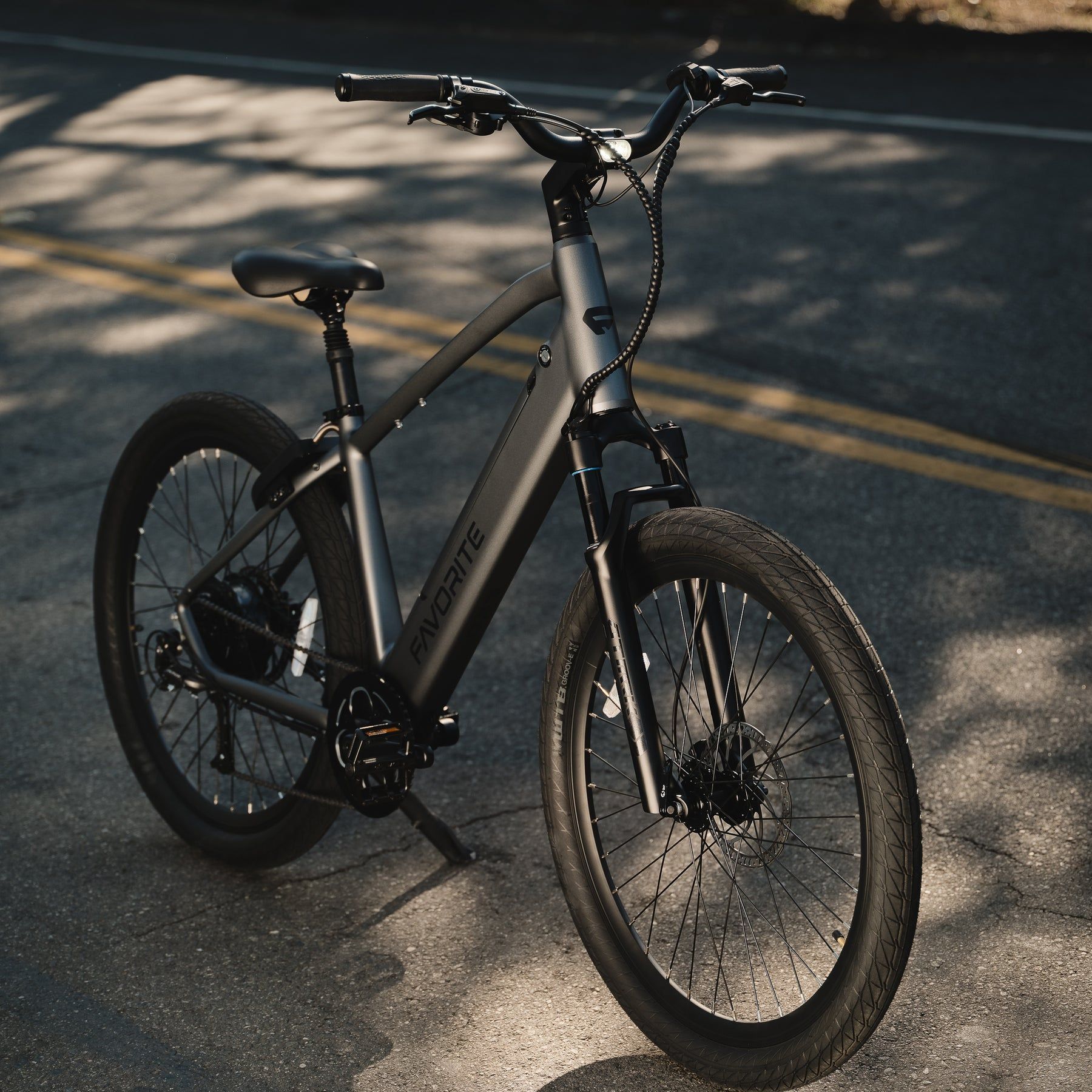A black bicycle is parked on the side of the road
