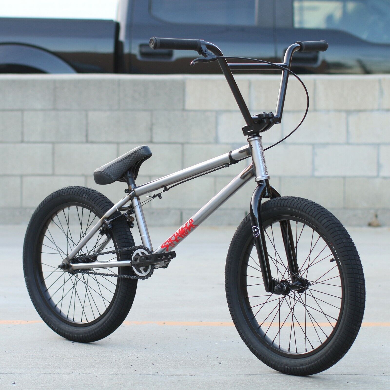 A bmx bike is parked in front of a truck