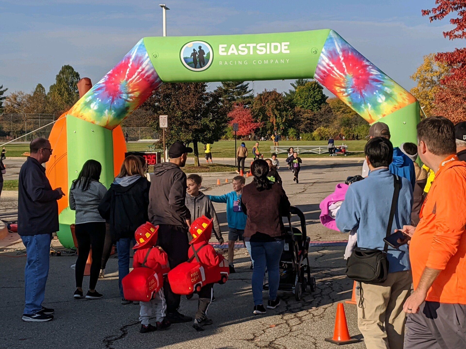People at an outdoor event with an inflatable arch that says