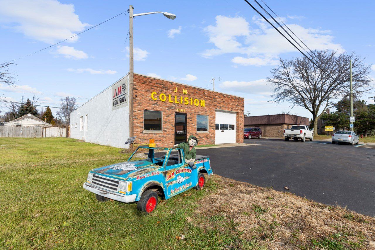 Blue toy truck in front of a brick building with 