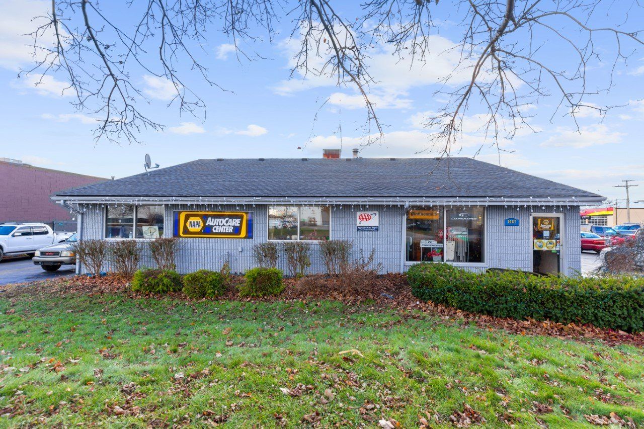 A one-story building with a sign that reads 