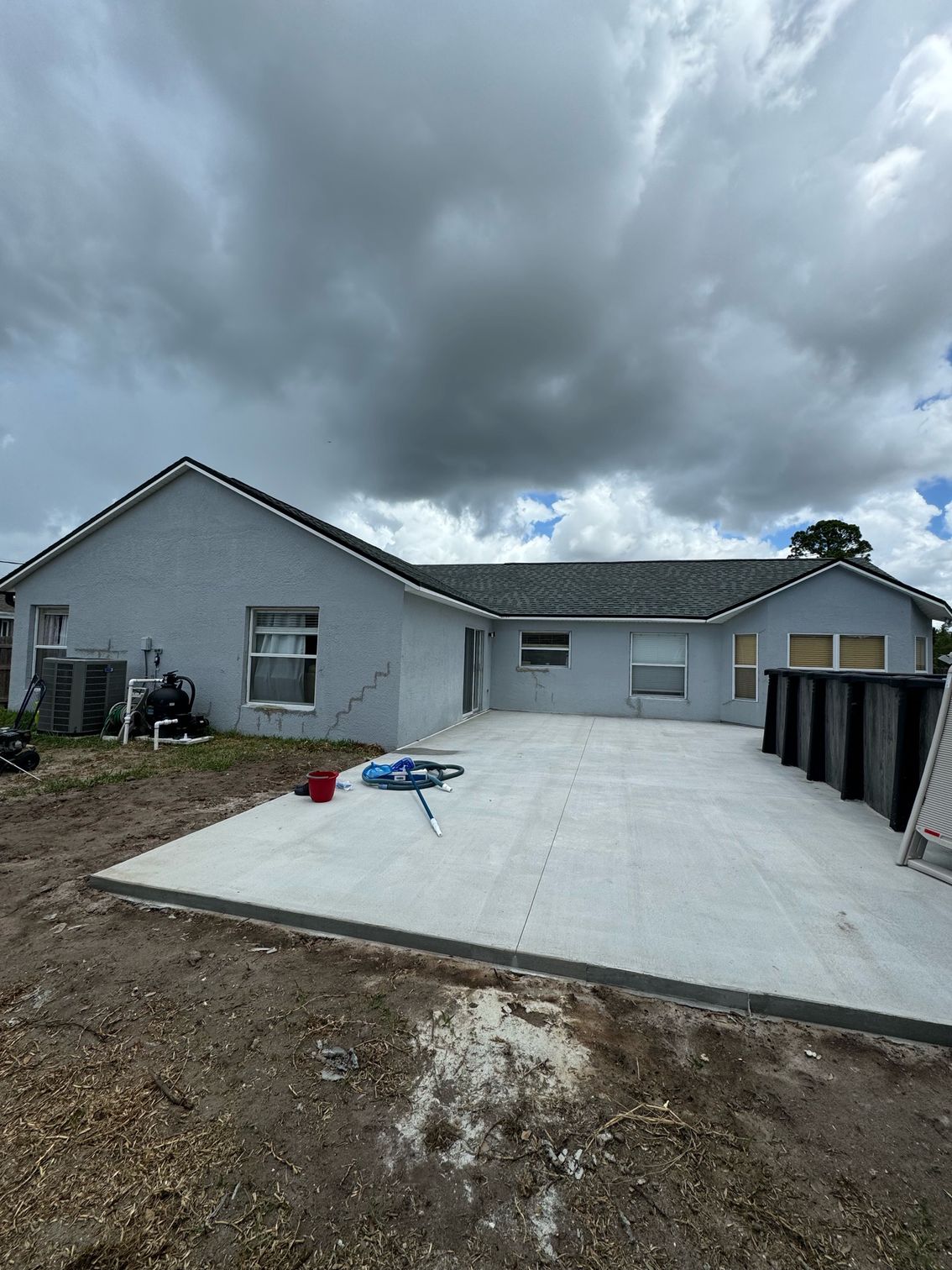 A house with a concrete driveway in front of it.