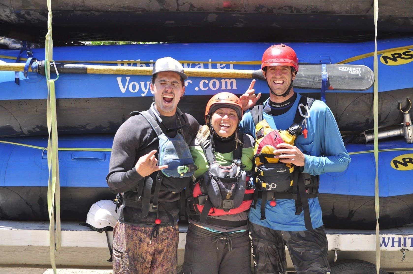 three people in rafting gear smiling