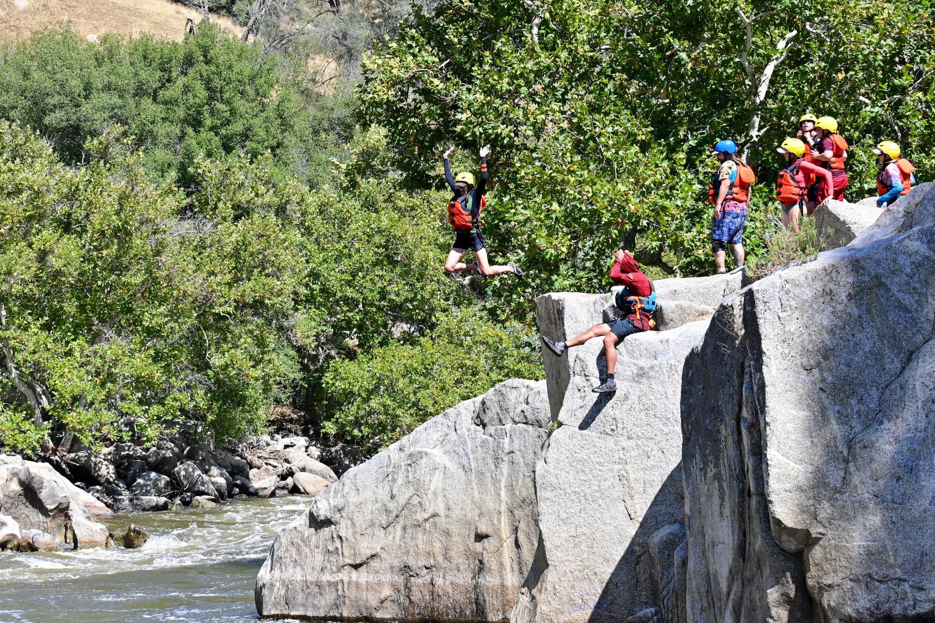 a person jumping off a rock