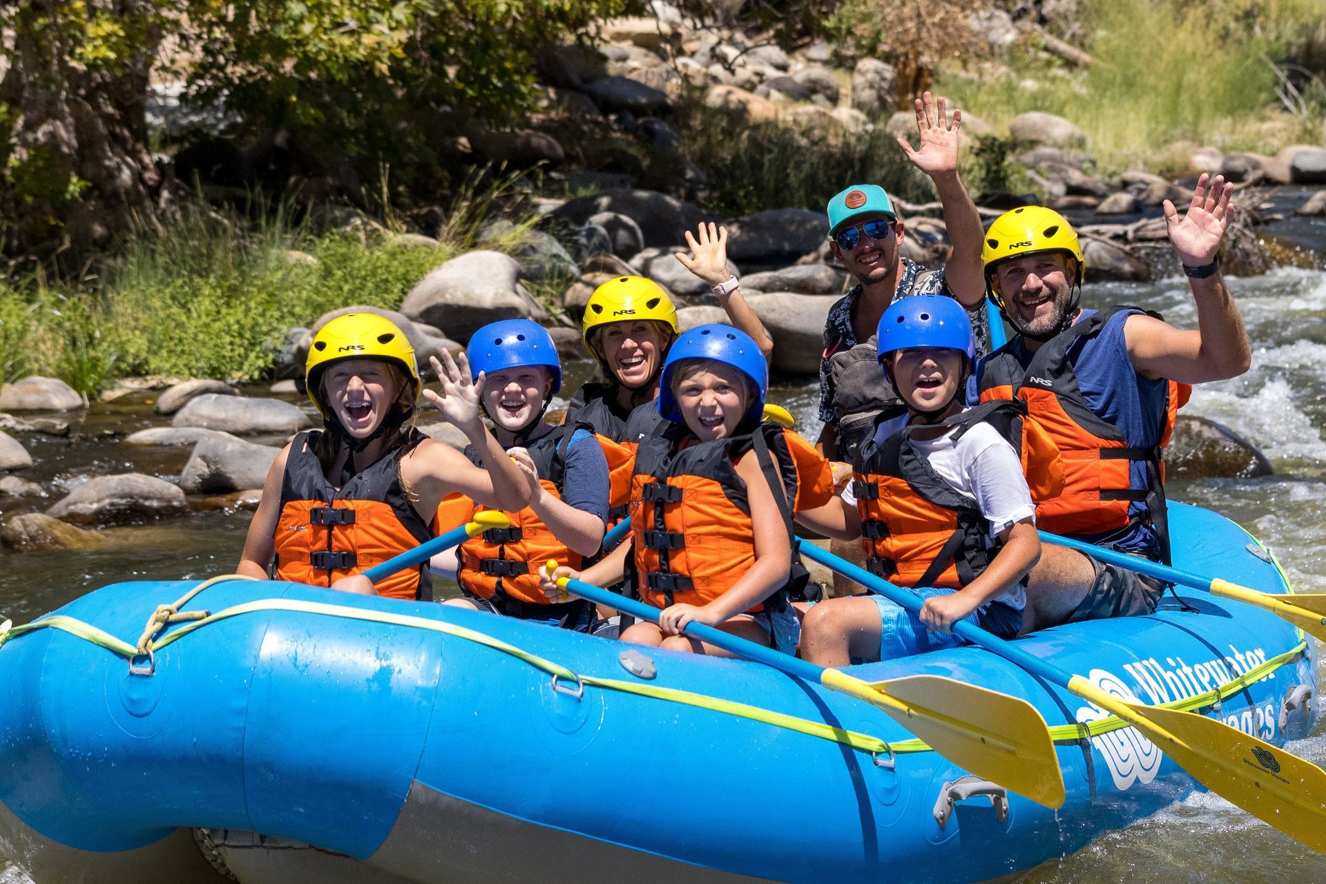 A group of people are riding a raft down a river.