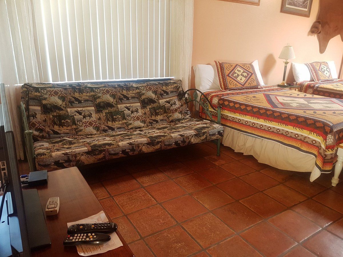 There is a couch and two beds in the room.