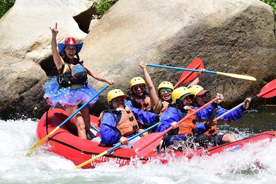 a woman in a tutu on a raft with people