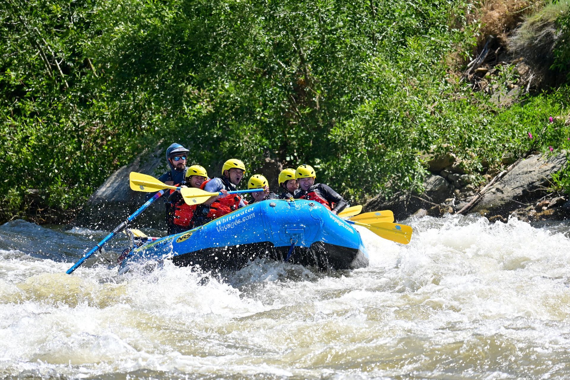 A group of people are rafting down a river.