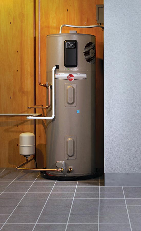 Water heater in a corner, with copper pipes, against wood paneling and tile floor.