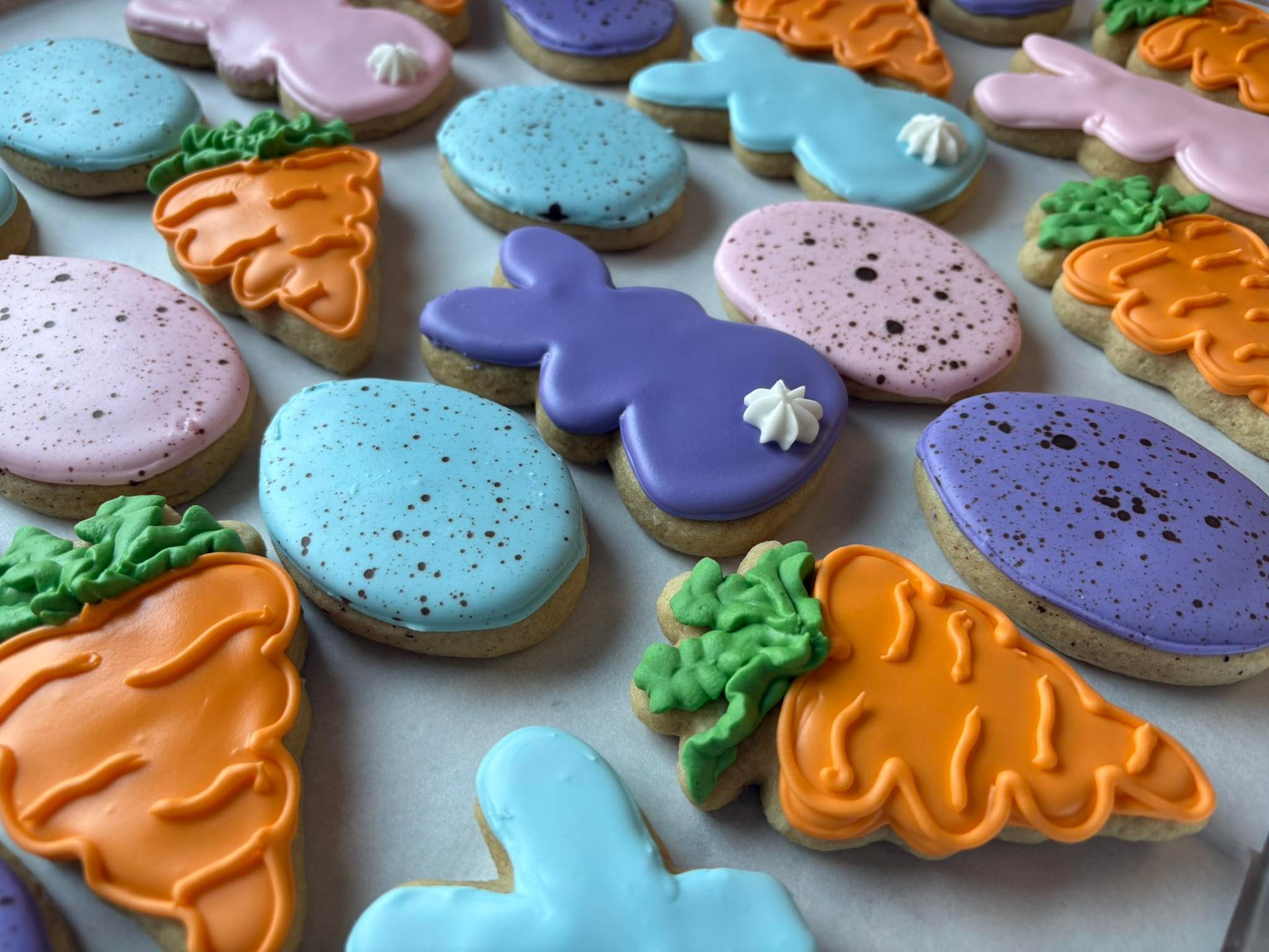 Easter cookies: carrots, bunnies, and speckled eggs, iced in pastel colors. Base Camp Bakery Gunnison, Colorado https://share.google/AgqUzUKNzsb0ThlP5, https://www.facebook.com/BaseCampBakery1, https://www.instagram.com/basecampbakery_81230